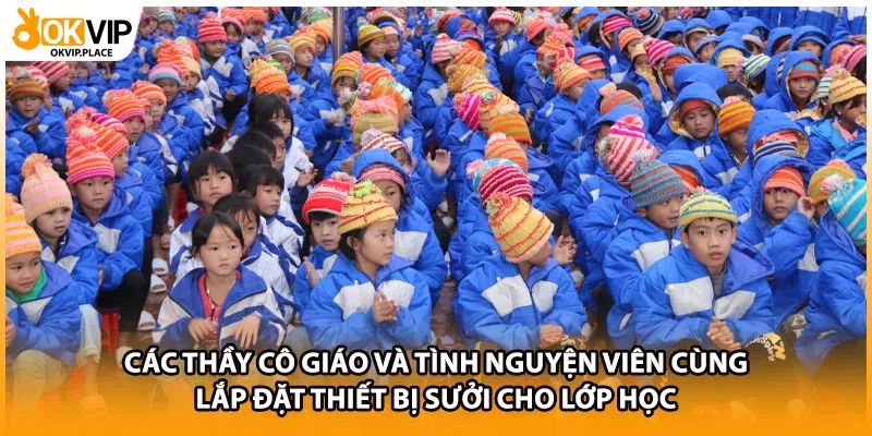 Các thầy cô giáo và tình nguyện viên cùng lắp đặt thiết bị sưởi cho lớp học